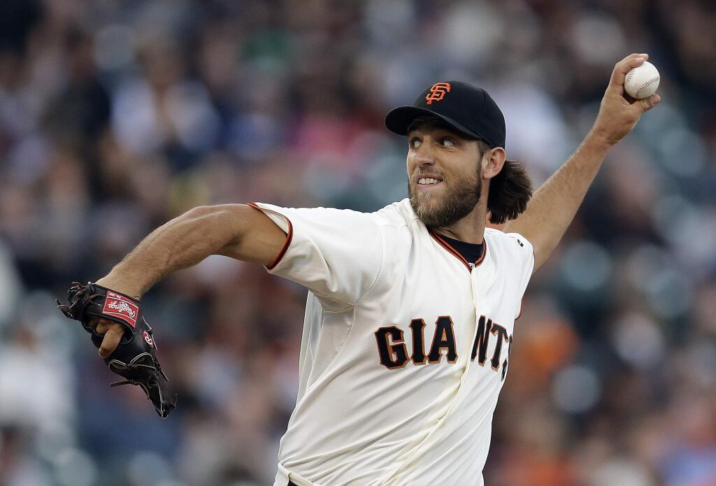 San Francisco Giants' Madison Bumgarner works against the Pittsburgh Pirates in the first inning of a baseball game Monday, July 28, 2014, in San Francisco. (AP Photo/Ben Margot)