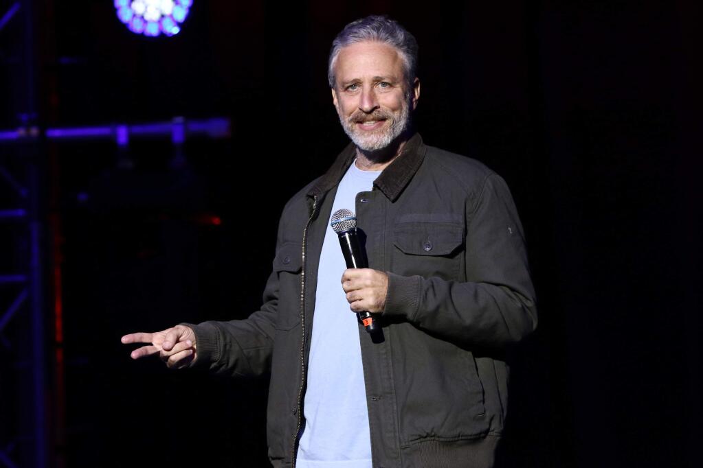 FILE - In this Tuesday, Nov. 10, 2015, file photo, comedian Jon Stewart performs at the 9th Annual Stand Up For Heroes event, in New York. Stewart delivered a riff reminiscent of his 'Daily Show' days during an appearance on CBS' 'Late Show with Stephen Colbert' on July 21, 2016. (Photo by Greg Allen/Invision/AP, File)