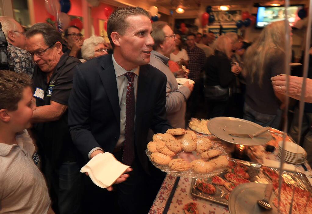 Senator Mike McGuire hands out cookies at the Democrat victory party at the Union Hotel Restaurant on College Ave. in Santa Rosa, Tuesday, Nov, 6, 2018. (Kent Porter / The Press Democrat) 2018