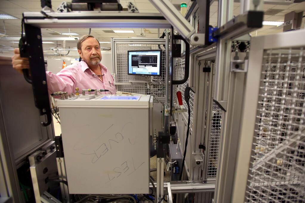 Dan Fine, with Volt, loads an instrument into an automated test system, named Yellowstone, at the Keysight Technologies headquarters, in Santa Rosa on Tuesday, Oct. 21, 2014. (CHRISTOPHER CHUNG/ PD)