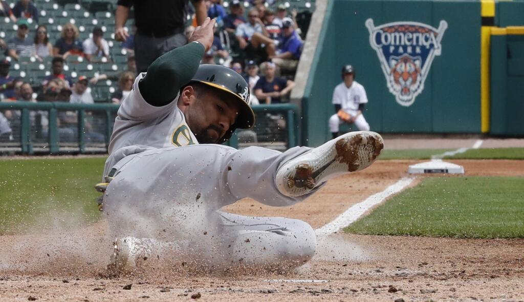 Oakland Athletics' Marcus Semien scores from third on a wild pitch during the third inning of a baseball game against the Detroit Tigers, Thursday, May 16, 2019, in Detroit. (AP Photo/Carlos Osorio)