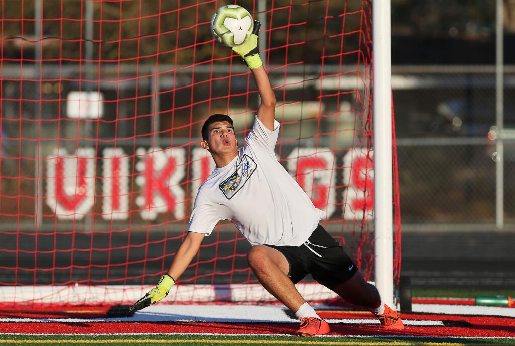 Montgomery goalie Emmanuel Padilla plays a shot on goal during practice in Santa Rosa on Thursday, January 2, 2020. (Christopher Chung / The Press Democrat)