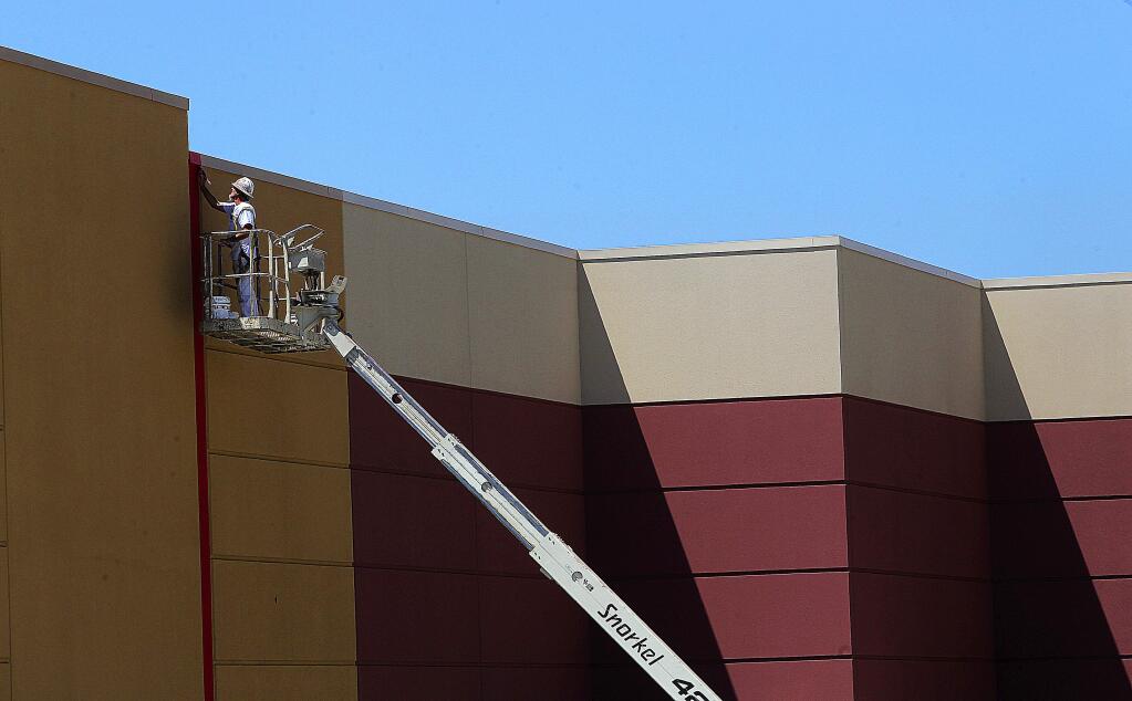 Painters put the final red line on the outside of the the new Target building at Coddingtown Mall.
