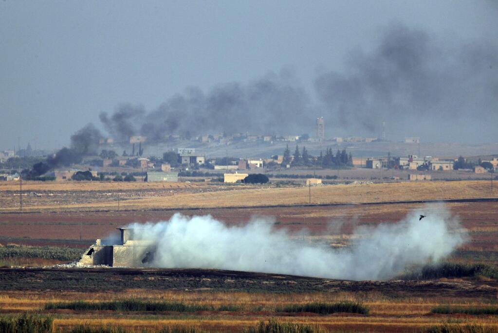 In this photo taken from the Turkish side of the border between Turkey and Syria, in Akcakale, Sanliurfa province, southeastern Turkey, smoke billows from targets inside Syria during bombardment by Turkish forces Wednesday, Oct. 9, 2019. Turkey launched a military operation Wednesday against Kurdish fighters in northeastern Syria after U.S. forces pulled back from the area, with a series of airstrikes hitting a town on Syria's northern border. (AP Photo/Lefteris Pitarakis)