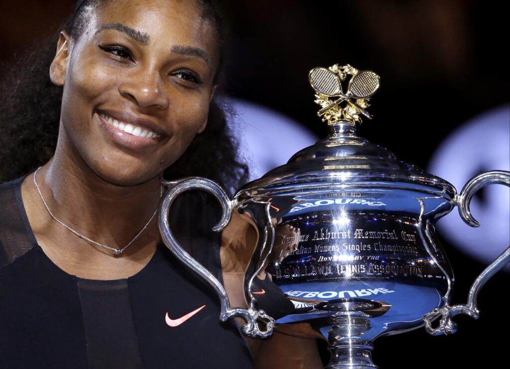 FILE - In this Jan. 28, 2017, file photo, United States' Serena Williams holds her trophy after defeating her sister Venus during the women's final at the Australian Open tennis championships in Melbourne, Australia. Williams and Alexis Ohanian got married at the Contemporary Arts Center in New Orleans, according to a story and photos posted on Vogue's website on Friday night, Nov. 17, 2017.Vogue said the celebrity guests at Thursday's ceremony included Beyonce and Kim Kardashian West. (AP Photo/Aaron Favila, File)