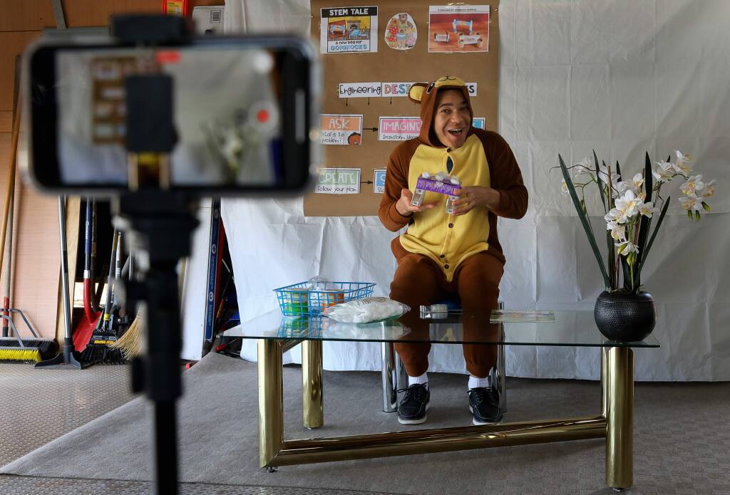 Ryan Kurada records himself teaching a STEM project related to 'Goldilocks and The Three Bears' for his University Elementary at La Fiesta transitional kindergarten and kindergarten split class in his garage in Rohnert Park on Monday, April 6, 2020. (Christopher Chung/ The Press Democrat)