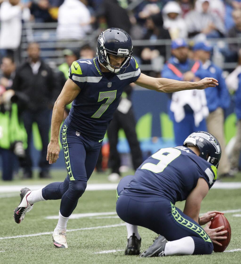 Seattle Seahawks Blair Walsh (7) kicks his second field goal of the first half of an NFL football game against the San Francisco 49ers as Jon Ryan (9) holds, Sunday, Sept. 17, 2017, in Seattle. (AP Photo/Elaine Thompson)