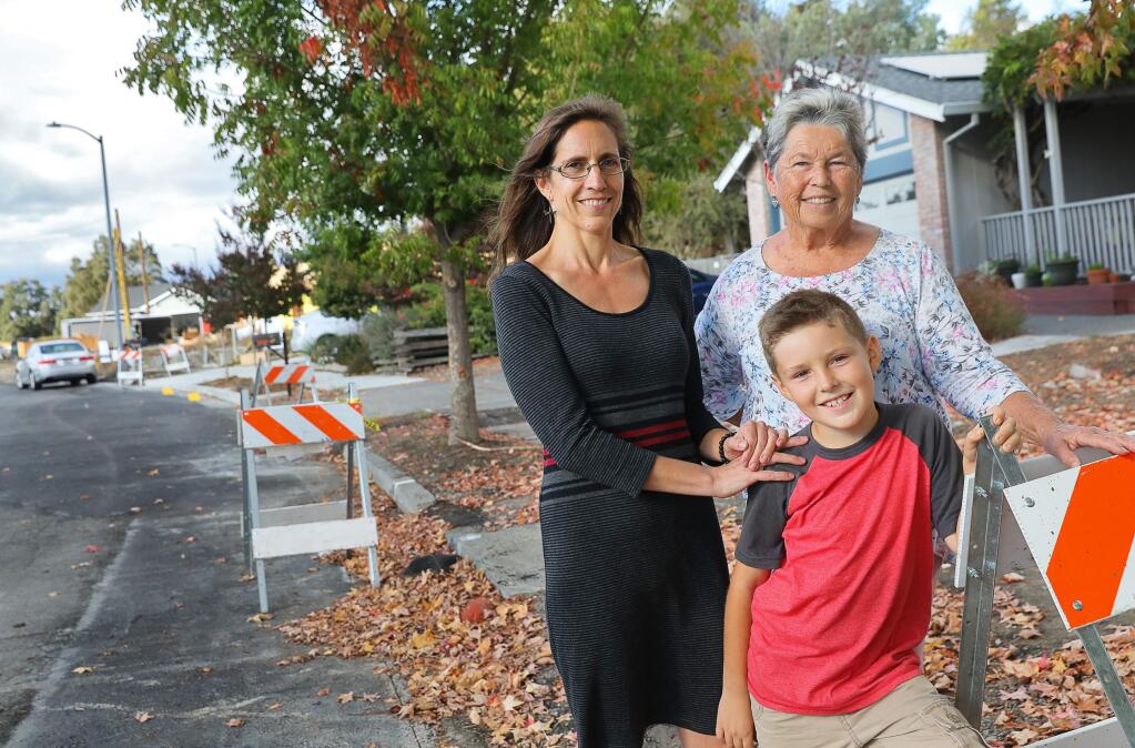 The home that Judy Crowner, right, lives in with her grandson, Elijah Matson, 8, and daughter, Melissa Matson, on Skyview Drive was saved during the Tubbs fire through the efforts of about eight different people. (Christopher Chung/ The Press Democrat)