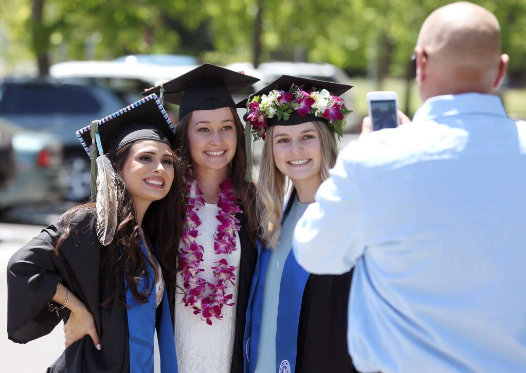 Graduates from left, Christina Clarke of Santa Rosa, Audrey Patterson of Rohnert Park, and Kristine Ricossa of Rohnert Park, pose before they graduate, at School of Science and Technology Commencement 2018 ceremonies, Sonoma State University in Rohnert Park, on Saturday, May 19, 2018. (Photo by Darryl Bush / For The Press Democrat)