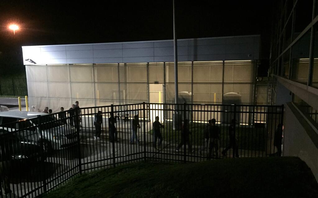 In this image provided by Jodie Bowers, detainees are escorted into an Immigration and Customs Enforcement (ICE) facility, early Wednesday, June 20, 2018, in Brooklyn Heights, Ohio. More than 100 workers were arrested Tuesday, at an Ohio meatpacking plant by federal agents following a yearlong immigration investigation, the second large-scale raid within the state in the past two weeks. (Jodie Bowers via AP)