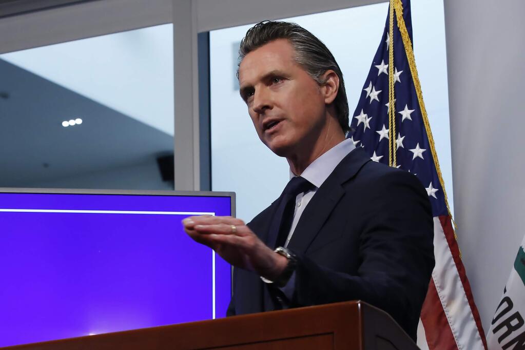 FILE- In this Tuesday April 14, 2020, file photo, California Gov. Gavin Newsom discusses an outline for what it will take to lift coronavirus restrictions, during a news conference at the Governor's Office of Emergency Services in Rancho Cordova, Calif. On Wednesday, April 22, Newson announced hospitals can resume scheduled surgeries. It's the first significant change to the state's stay-at-home order. (AP Photo/Rich Pedroncelli, File)
