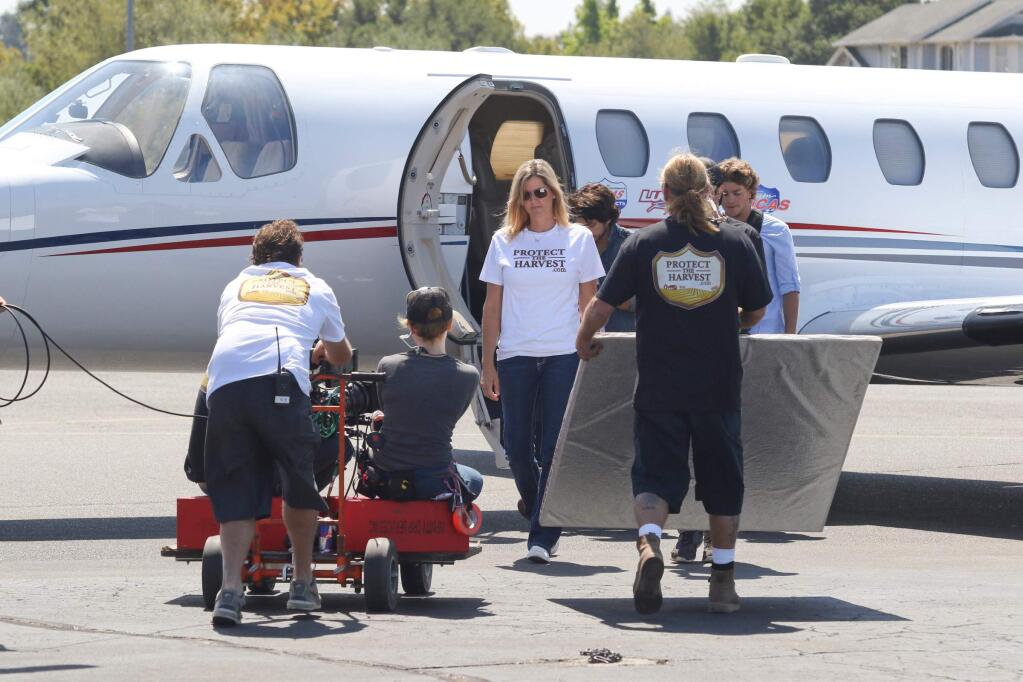 Petaluma's Heidi Marks stands in for Sharon Stone as a film crew for ESX Entertainment works filming 'Running Wild' at the Petaluma Municipal Airport in Petaluma on Friday, August 21, 2015. (SCOTT MANCHESTER/ARGUS-COURIER STAFF)