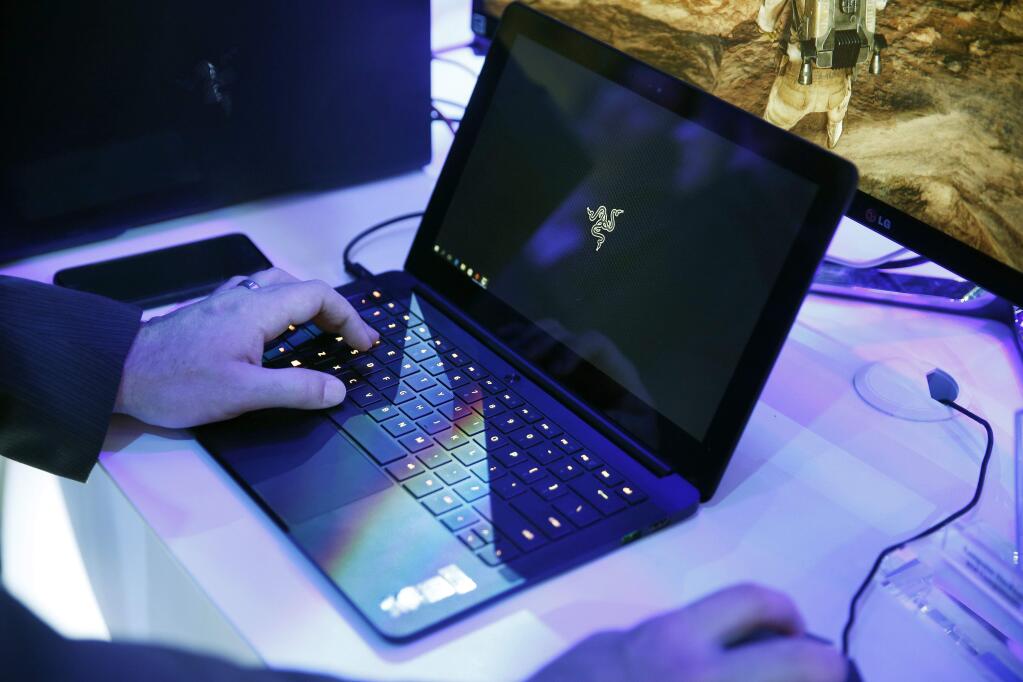 FILE - In this Jan. 7, 2016 file photo, a laptop is seen in Las Vegas. Royal Jordanian Airlines is advising passengers that laptops, iPads, cameras and other electronics won't be allowed in carry-on luggage for U.S.-bound flights starting Tuesday, March 21, 2017. (AP Photo/John Locher, File)
