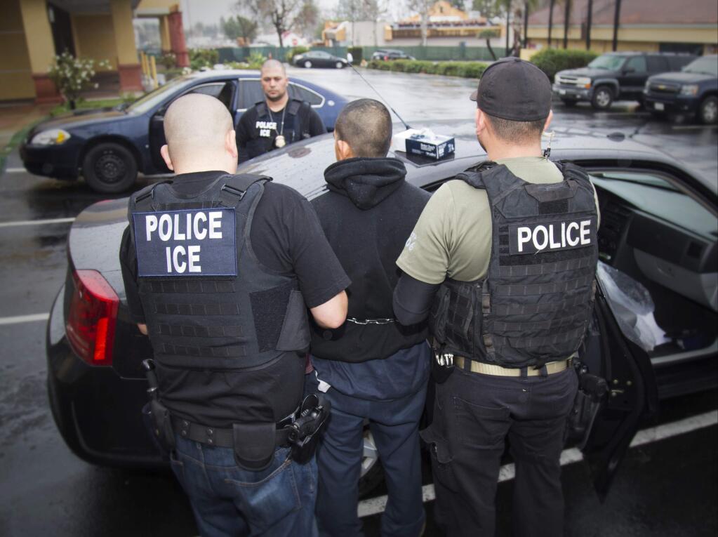 In this photo taken Feb. 7, 2017, released by U.S. Immigration and Customs Enforcement, an arrest is made during a targeted enforcement operation conducted by U.S. Immigration and Customs Enforcement (ICE) aimed at immigration fugitives, re-entrants and at-large criminal aliens in Los Angeles. The Trump administration is wholesale rewriting the U.S. immigration enforcement priorities, broadly expanding the number of immigrants living in the U.S. illegally who are priorities for deportation, according to a pair of enforcement memos released Tuesday, Feb. 21, 2017. (Charles Reed/U.S. Immigration and Customs Enforcement via AP)