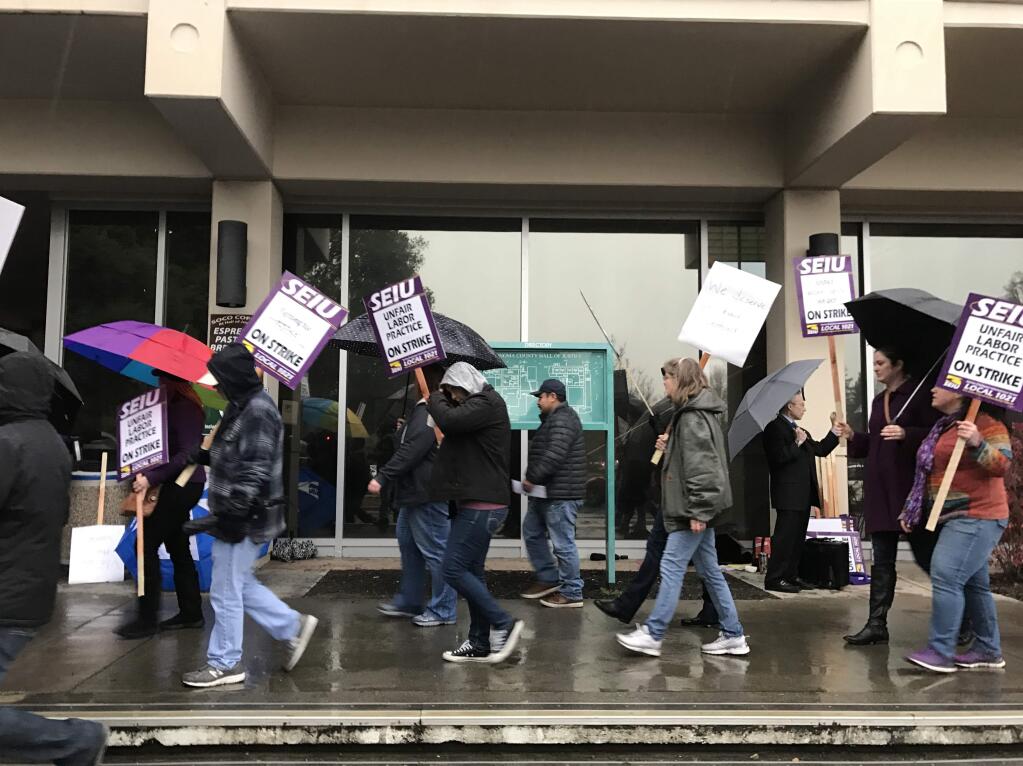 Court clerks, legal assistants and court reporters strike in front of the Sonoma County Superior Court in Santa Rosa on Wednesday, Jan. 18, 2017. (BETH SCHLANKER/ PD)