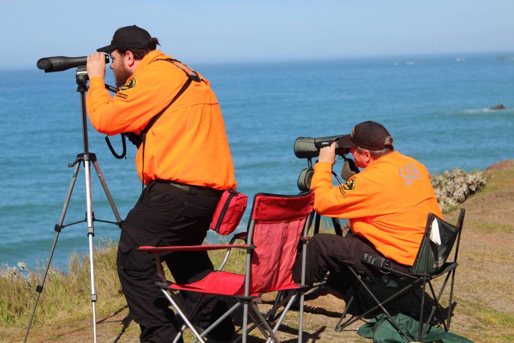 Volunteers with the Mendocino County Sheriff's Office Search and Rescue team searches the waters off the coast using a telescope near Mendocino, Calif. on Thursday, March 29, 2018 for any signs of the three children who remain missing after a mysterious wreck now under investigation. (Kale Williams/The Oregonian via AP)