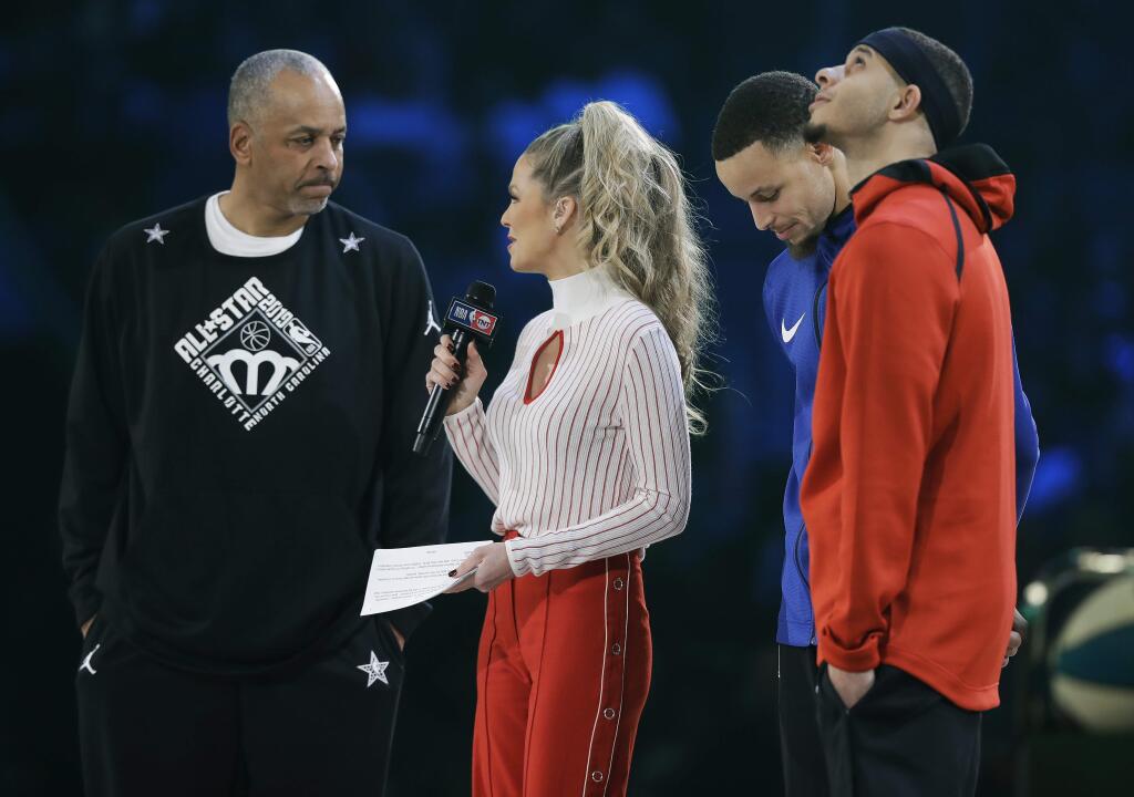 Dell Curry and son's Stephen Curry and Seth Curry are interviewed during the NBA All-Star 3-Point contest, Saturday, Feb. 16, 2019, in Charlotte, N.C. (AP Photo/Chuck Burton)