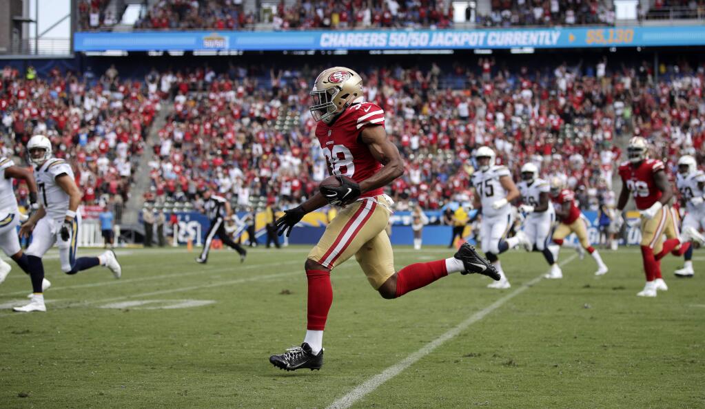 San Francisco 49ers defensive back Antone Exum runs in for a touchdown after intercepting a pass during the first half of against the Los Angeles Chargers, Sunday, Sept. 30, 2018, in Carson. (AP Photo/Jae Hong)