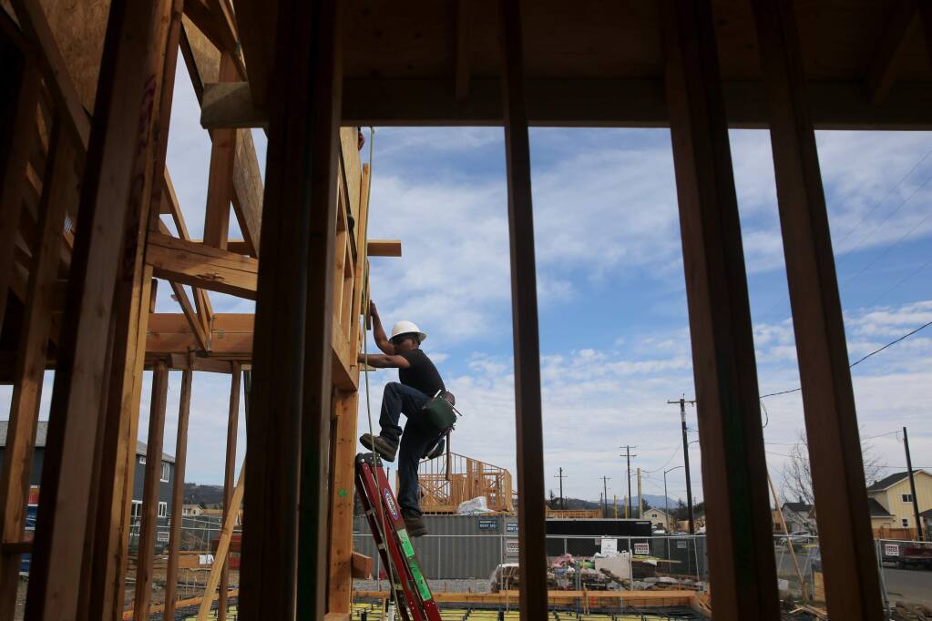 Alejandro Carradas of R&R Framing Inc, works to build a house in Coffey Park in Santa Rosa on Tuesday, October 23, 2018. (BETH SCHLANKER/ The Press Democrat)