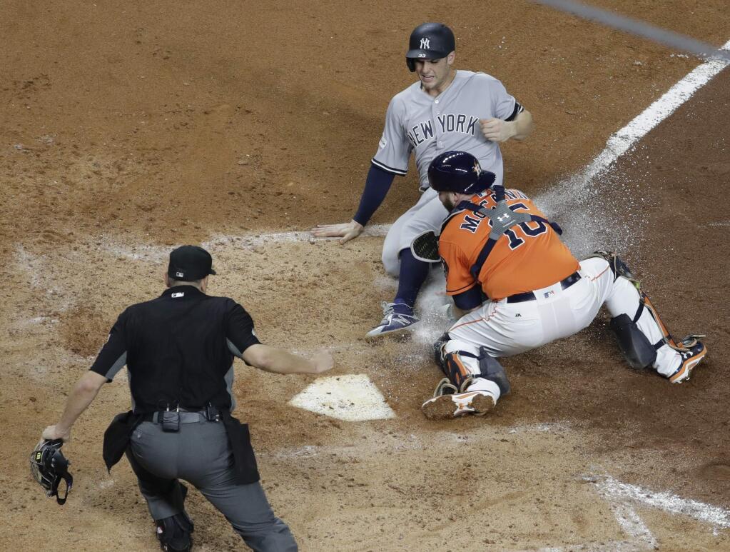 Houston Astros catcher Brian McCann tags out the New York Yankees' Greg Bird at home during the fifth inning of Game 1 of the American League Championship Series Friday, Oct. 13, 2017, in Houston. (AP Photo/David J. Phillip)