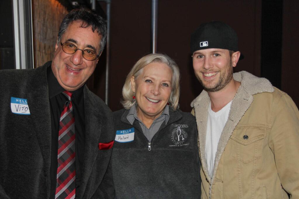 Volunteers greet and seat Vito LaMorte, Helen Medina and Porter Anthony at Cinnabar Theater's Crab Feed fundraiser at Lagunitas in Petaluma on Tuesday, January 13, 2015. (Victoria Webb/For The Argus-Courier)