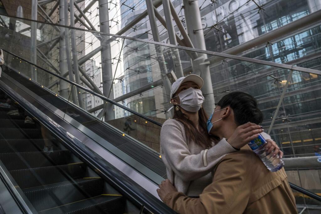 A couple at a mall in Hong Kong on Feb. 13, 2020. Across the world, the coronavius pandemic is radically altering approaches to love, dating, sex and family relations. (Lam Yik Fei/The New York Times)