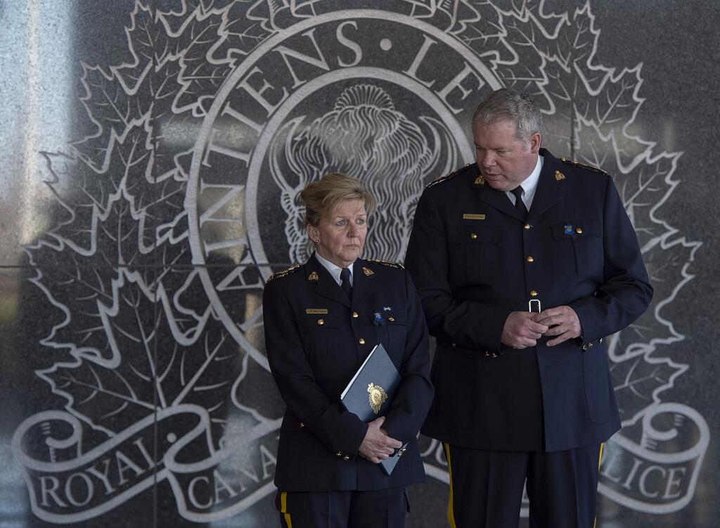 Royal Canadian Mounted PoliceP Assistant Commissioner Lee Bergerman, left, and Chief Superintendent Chris Leather wait for the start of a news conference at RCMP headquarters in Dartmouth, Nova Scotia on Sunday, April 19, 2020. (Andrew Vaughan/The Canadian Press via AP)