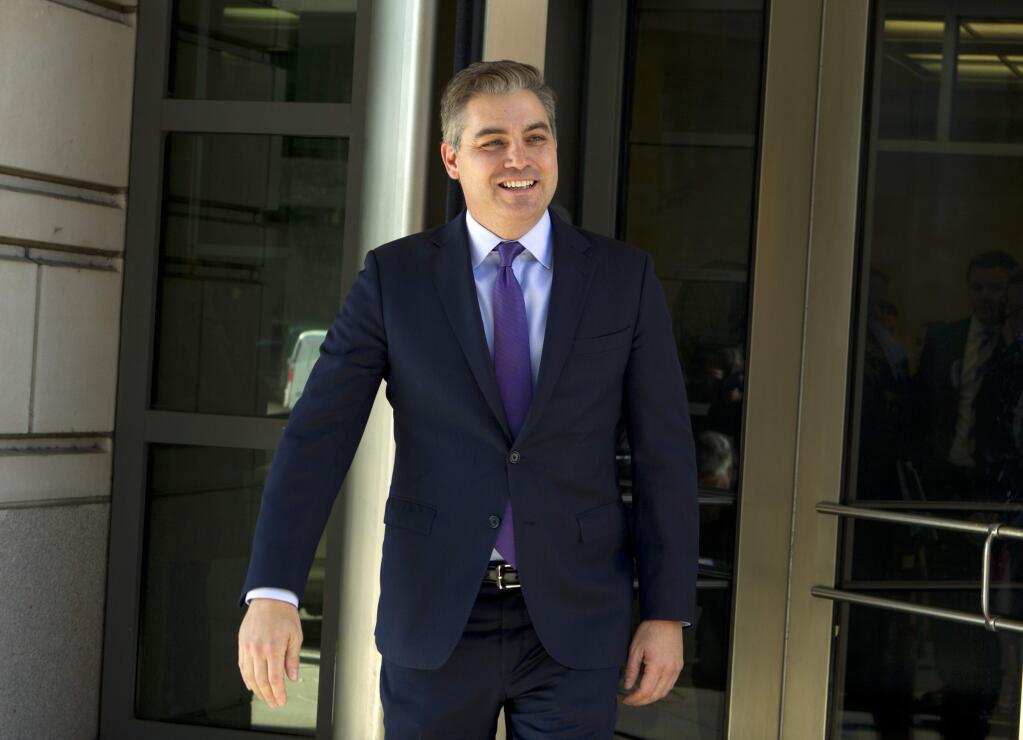 CNN's Jim Acosta walks out of the U.S. District Courthouse with a smile, Friday, Nov. 16, 2018, in Washington. U.S. District Court Judge Timothy Kelly ordered the White House to immediately return Acosta's credentials. He found that Acosta was “irreparably harmed” and dismissed the government's argument that CNN could send another reporter in Acosta's place to cover the White House. (AP Photo/Jose Luis Magana)