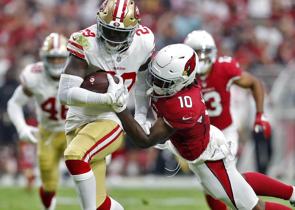 San Francisco 49ers strong safety Jaquiski Tartt intercepts a pass intended for Arizona Cardinals wide receiver Chad Williams during the first half, Sunday, Oct. 28, 2018, in Glendale, Ariz. (AP Photo/Ralph Freso)