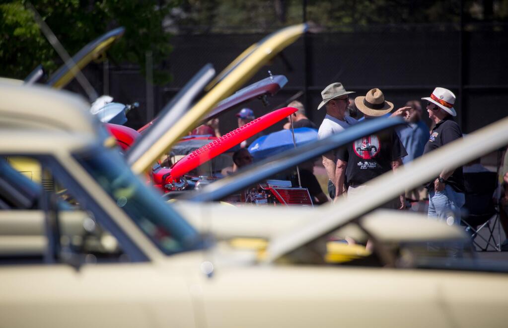 Guests check out classic and custom cars during Maria Carrillo High School auto shop program's 1st annual REDLINE CarFEST car show at the high school in Santa Rosa, Calif. Saturday April 1, 2017. (Jeremy Portje / For The Press Democrat)