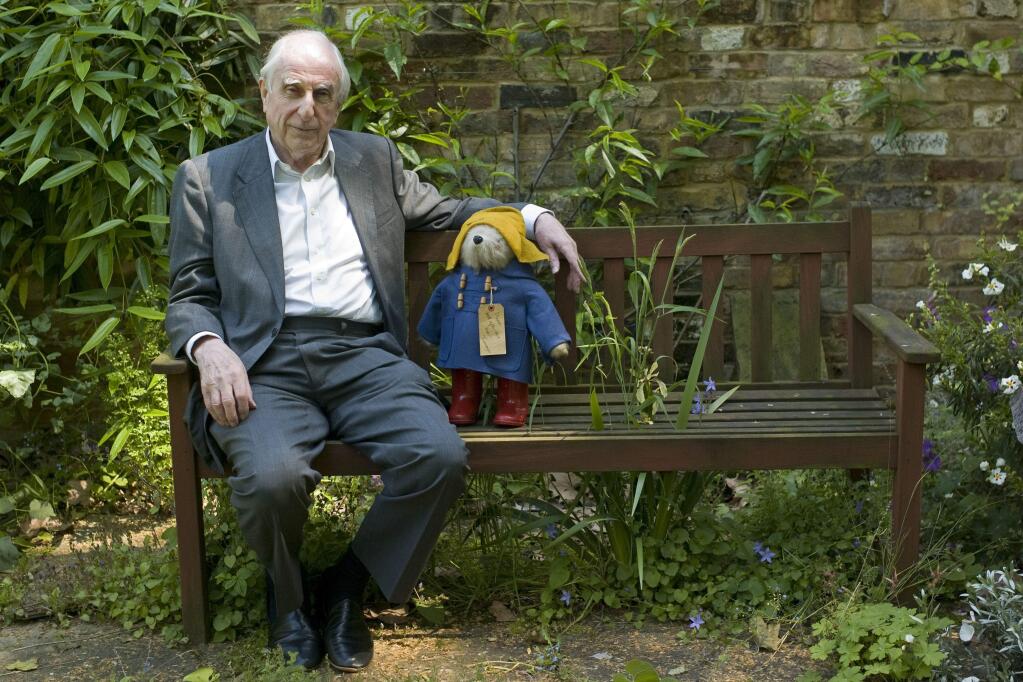 FILE - In this Thursday, June 5, 2008 file photo, British author Michael Bond sits with a Paddington Bear toy during an interview with The Associated Press in London. Publisher HarperCollins says Michael Bond, creator of globe-trotting teddy Paddington bear, died on Tuesday June 27, 2017, aged 91. (AP Photo/Sang Tan, File)