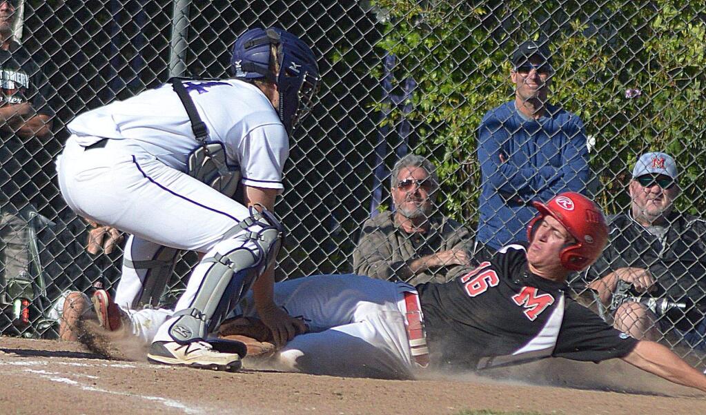 SUMNER FOWLER/FOR THE ARGUS-COURIERMontgomery base runner Travis Sheffer is tagged out at home by Petaluma catcher Nick Andrakin in NCS playoff game won by Montgomery, 10-1.