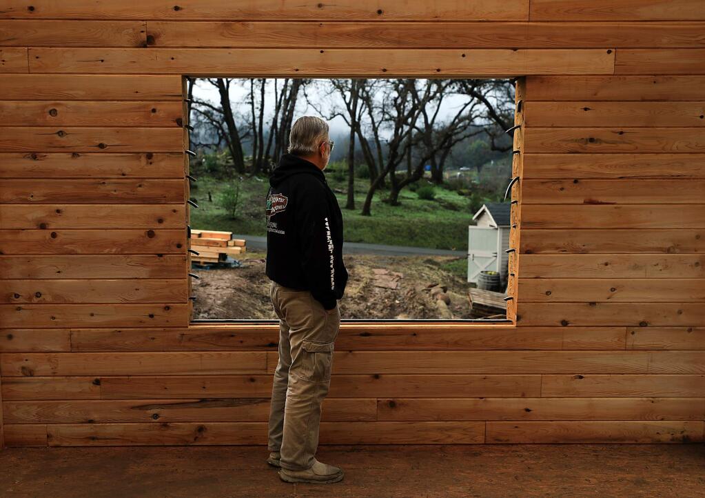 Gary Bayless contemplates the rebuilding of his log home in the Mark West area, Wednesday, Dec. 19, 2018. The Bayless home was razed during the Tubbs fire. (Kent Porter / The Press Democrat) 2018