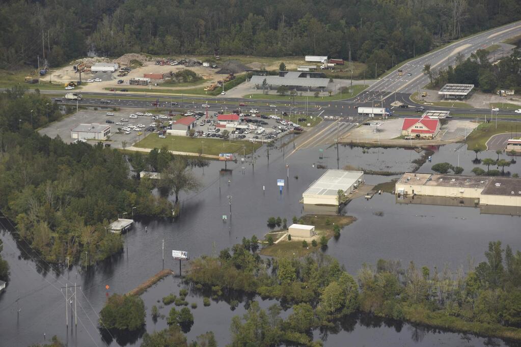 In this Monday, Sept. 24, 2018 photo, flood waters from the Neuse River cover the area a week after Hurricane Florence in Kinston, N.C. Monday Sept. 24, 2018. (Ken Blevins/The Star-News via AP)