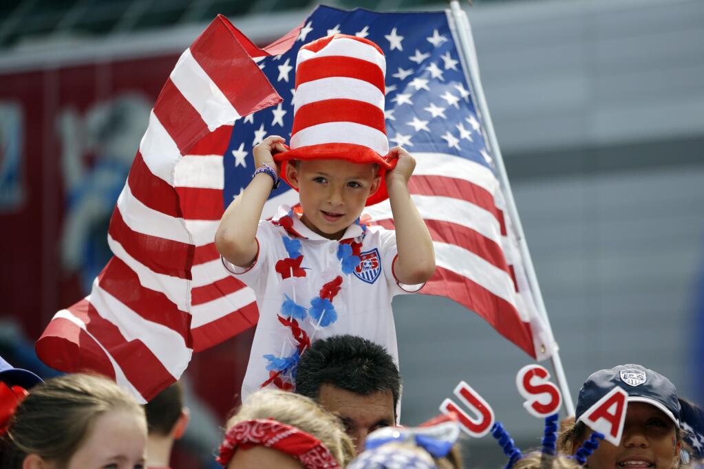 Keegan Bilboa, 6, of Springfield, Missouri, sits atop shoulders outside BC Place stadium before the FIFA Women's World Cup soccer championship between the United States and Japan later in the day, in Vancouver, British Columbia, Canada, Sunday, July 5, 2015. (AP Photo/Elaine Thompson)
