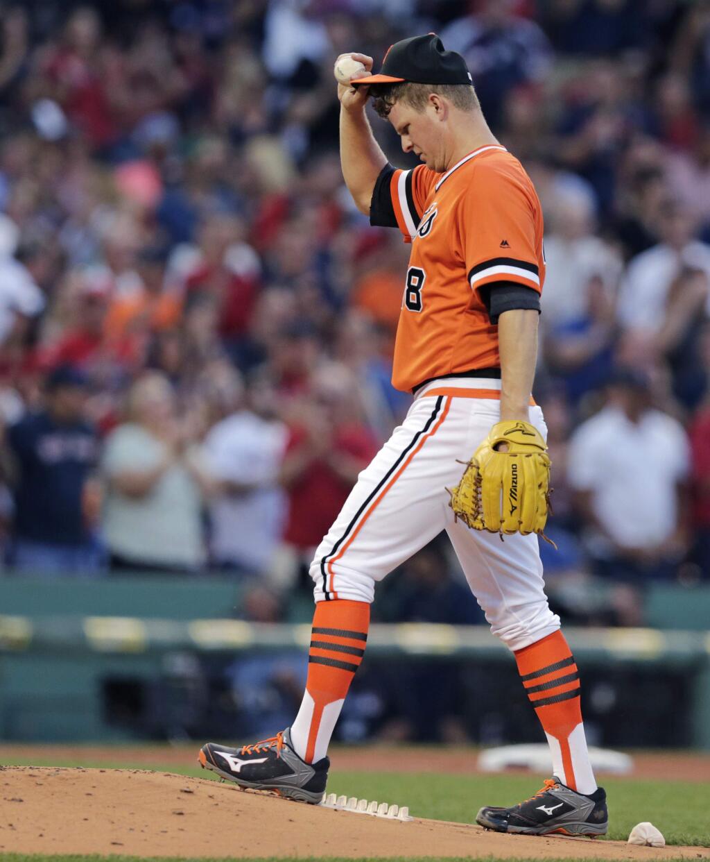 San Francisco Giants starting pitcher Matt Cain tugs on his cap as he walks back to the mound with a fresh baseball after giving up a home run to Boston Red Sox's Travis Shaw during second inning of a baseball game at Fenway Park, Wednesday, July 20, 2016, in Boston. (AP Photo/Charles Krupa)