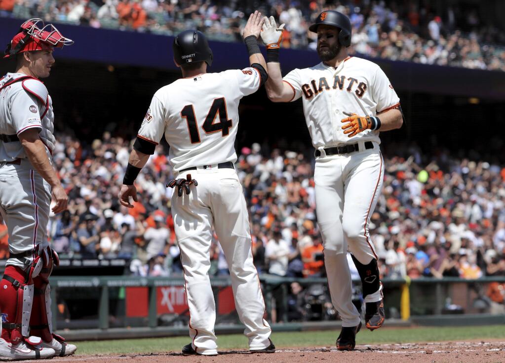 The San Francisco Giants' Evan Longoria, right, is congratulated by Scooter Gennett after hitting a two-run home run off the Philadelphia Phillies' Vince Velasquez (not shown) in the second inning in San Francisco, Saturday, Aug. 10, 2019. (AP Photo/Scot Tucker)