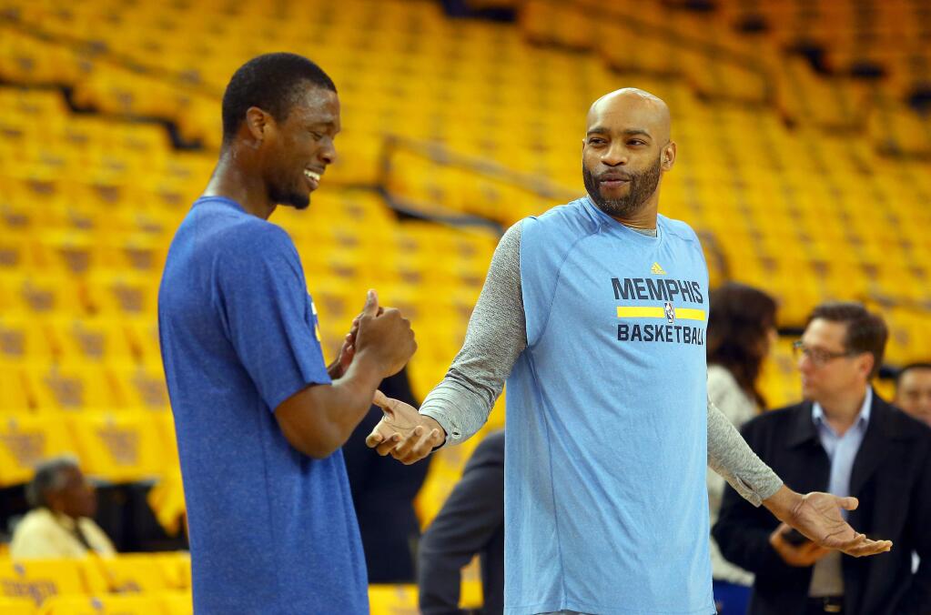 Golden State Warriors forward Harrison Barnes, left, and Memphis Grizzlies guard Vince Carter joke around as they hit the floor for practice before the start of Game 5 of the NBA Playoffs Western Conference Semifinals at Oracle Arena, in Oakland on Wednesday, May 13, 2015. (Christopher Chung/ The Press Democrat)