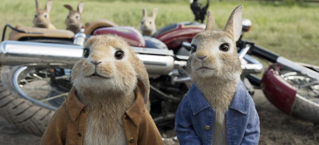 This image released by Columbia Pictures shows characters Benjamin, voiced by Colin Moody, left, and Peter Rabbit, voiced by James Corden and Cottontail in a scene from 'Peter Rabbit.' (Columbia Pictures/Sony via AP)