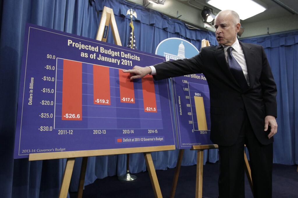 Gov. Jerry Brown points a chart during a budget news conference. (RICH PEDRONCELLI / Associated Press, 2013)