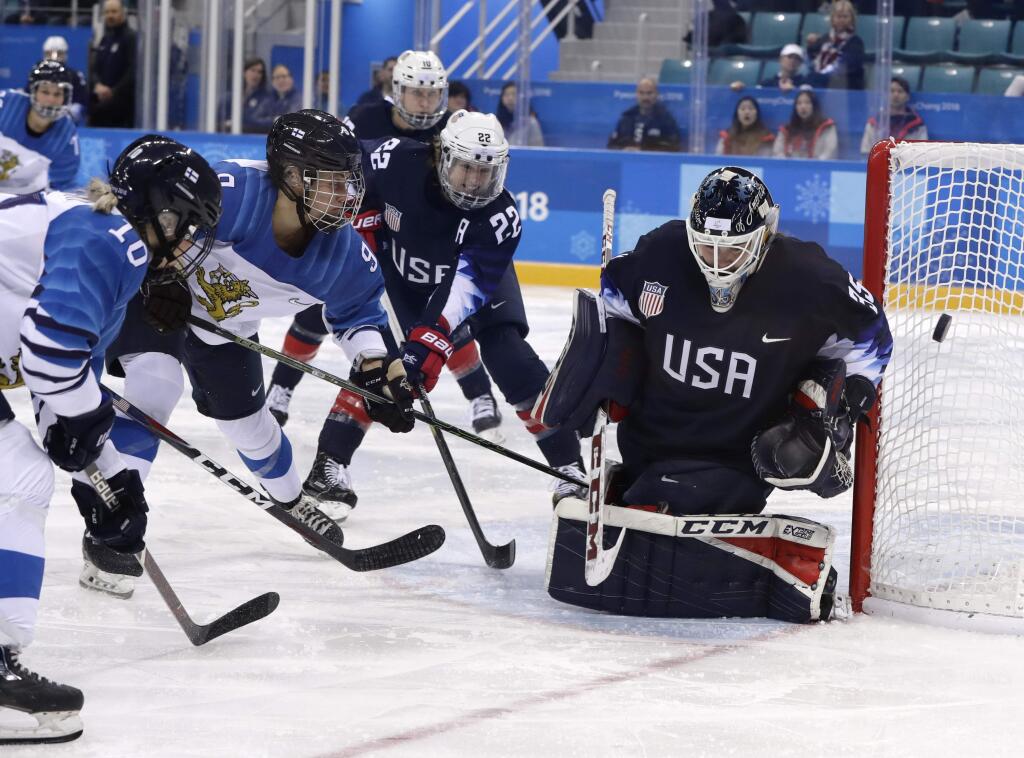 goalie Maddie Rooney (35), of the United States, deflects the puck during the third period of the semifinal round of the women's hockey game against Finland at the 2018 Winter Olympics in Gangneung, South Korea, Monday, Feb. 19, 2018. (AP Photo/Matt Slocum)