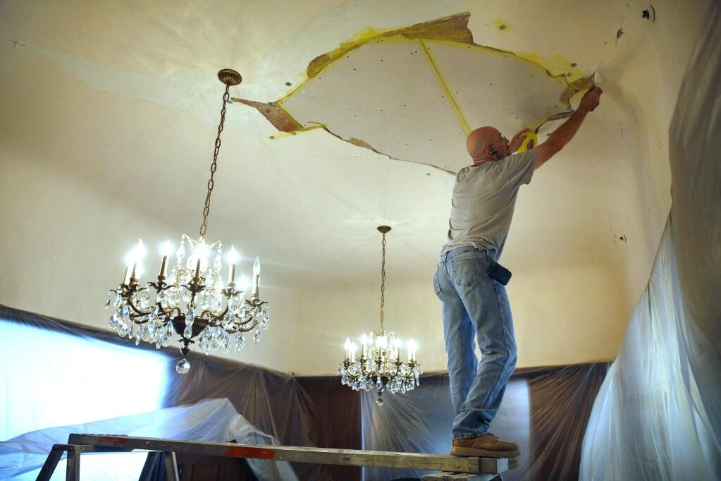 Ben Barnard of Frank's Drywall repairs sheetrock on a ceiling at the Cedar Gables Inn because of water damage from Sunday's earthquake on Wednesday, Aug. 27, 2014 in Napa. (BETH SCHLANKER/ The Press Democrat)
