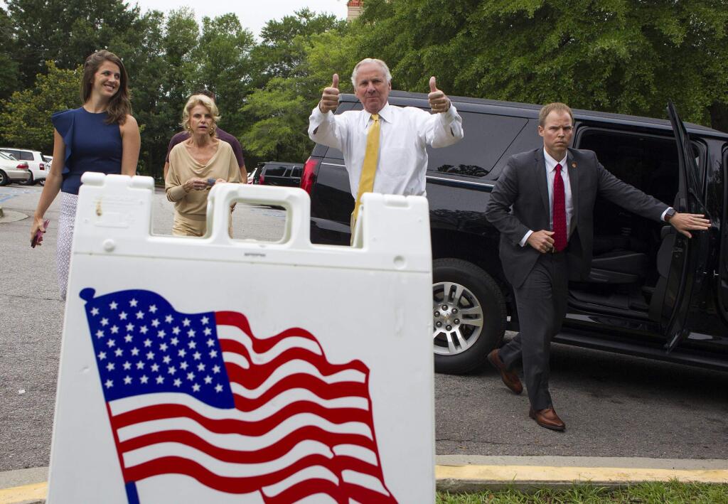 South Carolina Governor Henry McMaster gives a thumbs up as he arrives to vote in the South Carolina Primary, Tuesday, June 12, 2018 at the Lourie Center in Columbia, S.C. Arriving with McMaster is his daughter, Mary Rogers, left, and wife, Peggy, second from left. (Kevin Martin//The State via AP)