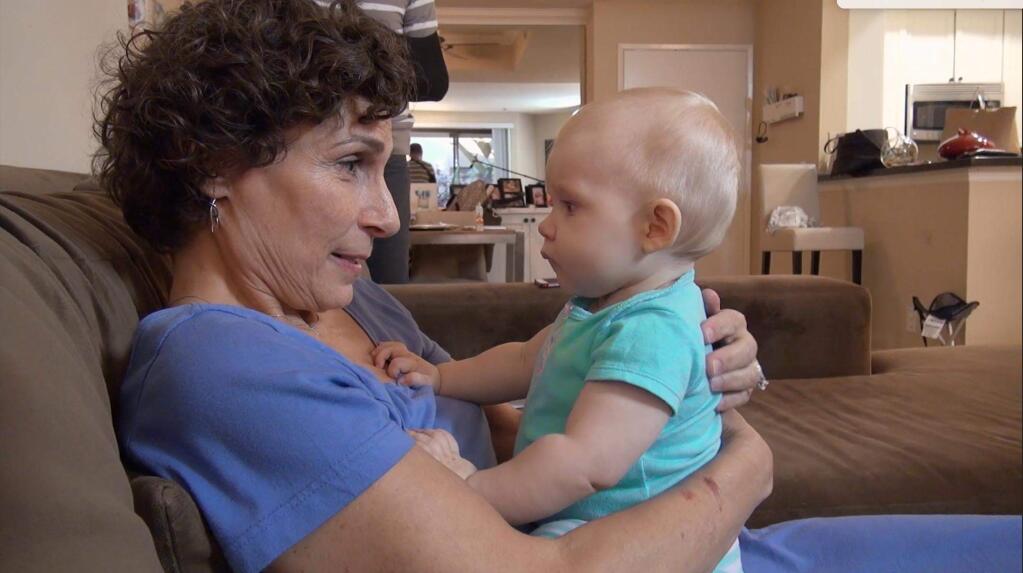 Sonoma County resident Mara Gordon holds 9-mont-old Sophie Ryan in a scene from the new documentary 'Weed the People' about families using cannabis to help ther cancer-stricken children. ('Weed the People')