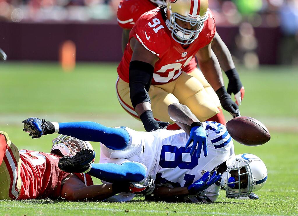Reggie Wayne of the Colts gathers in his own fumble as Ray McDonald of the niners defends. during the 49ers loss to Indianapolis 27-7 at Candlestick Park in San Francisco, Sunday Sept. 22. 2013. (Kent Porter / Press Democrat) 2013