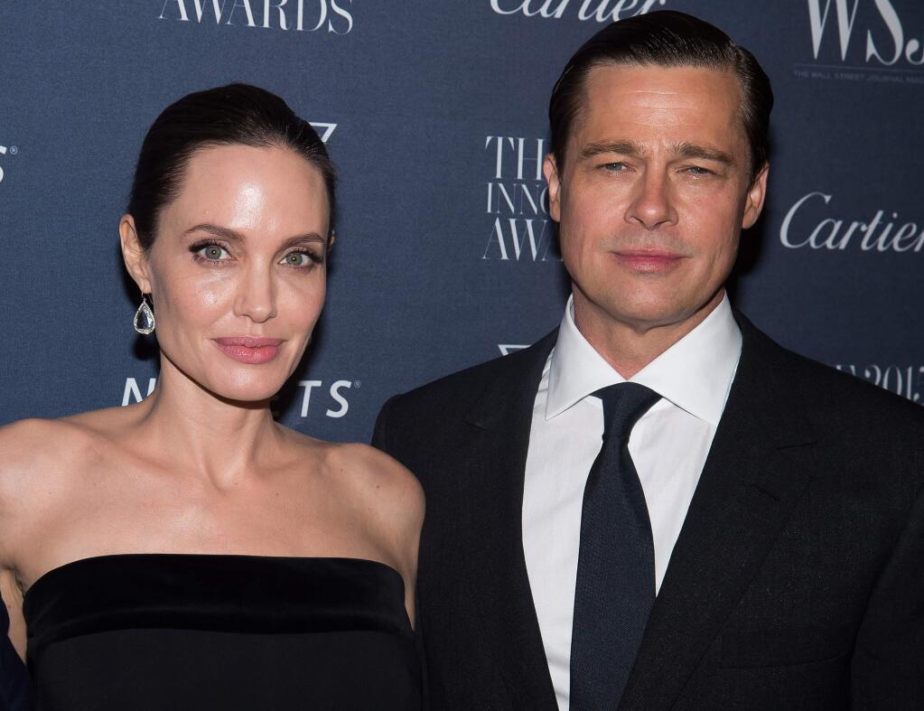 FILE - In this Nov. 4, 2015 file photo Angelina Jolie Pitt and Brad Pitt attend the WSJ Magazine Innovator Awards 2015 at The Museum of Modern Art in New York. Jolie has filed for divorce from Pitt, bringing an end to one of the world's most star-studded, tabloid-generating romances. (Photo by Charles Sykes/Invision/AP, File)
