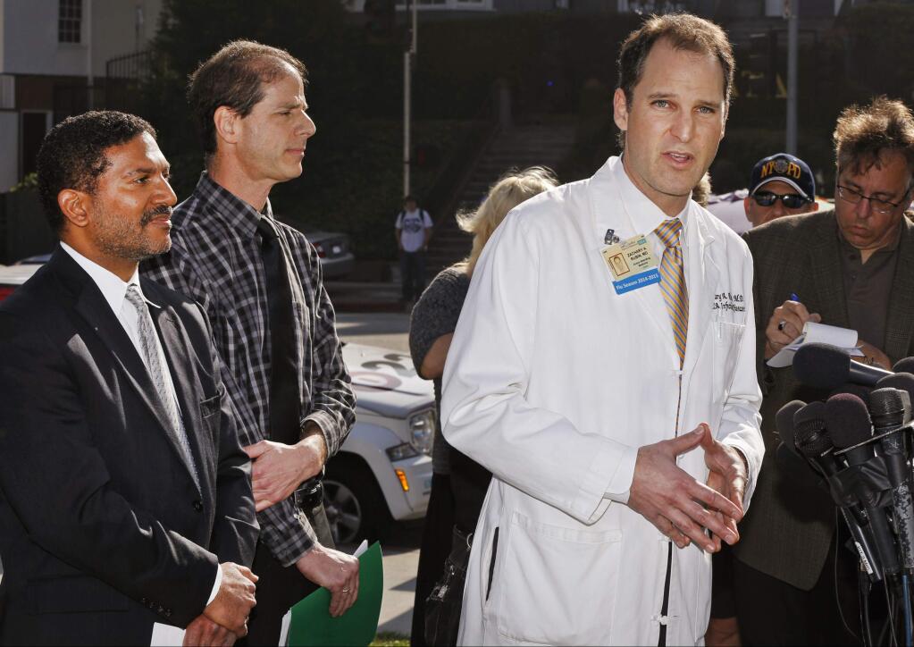 Dr. Zachary Rubin, medical director of clinical epidemiology and infection prevention at the Ronald Reagan UCLA Medical Center, right, takes questions from the media in Los Angeles Thursday, Feb. 19, 2015. Los Angeles County health officials say a 'superbug' bacterial outbreak at a local hospital doesn't pose any threat to public health. At left, Dr. Robert Cherry, chief medical and quality officer, UCLA Health System, and Dr. Benjamin Schwartz, deputy chief of the Acute Communicable Disease Control Program at the county Department of Public Health, middle. (AP Photo/Damian Dovarganes)
