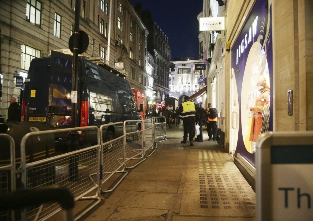 The scene outside the London Palladium in the west end of London after Oxford Circus station was evacuated Friday Nov. 24, 2017. British police said Friday they were responding to reports of an incident at Oxford Circus subway station, one of London's busiest. (Yui Mok/PA via AP)