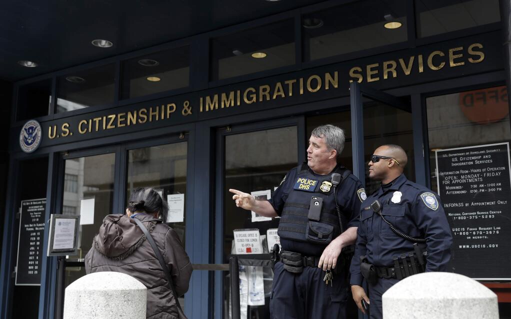 The entrance to the Immigration and Customs Enforcement office is guarded Wednesday, Feb. 28, 2018, in San Francisco. A top immigration official said Wednesday that about 800 people living illegally in Northern California were able to avoid arrest because of a weekend warning that Oakland Mayor Libby Schaaf put on Twitter.(AP Photo/Marcio Jose Sanchez)