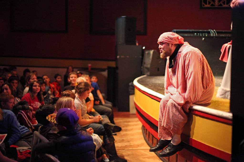 An actor from A Christmas Carol performs for an audience of 400 petaluma school kids for free at The Mystic Theater on December 3, 2014 (VICTORIA WEBB/FOR THE ARGUS-COURIER)